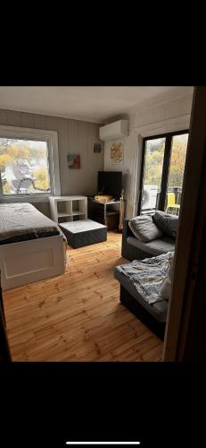 a living room with two beds and a couch at Nordstrand Well in Oslo