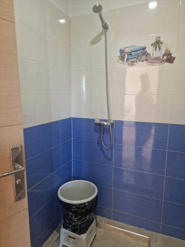 a blue and white bathroom with a toilet in it at APPARTEMENT DE LUXE 3 Façades in O Ben Slimane