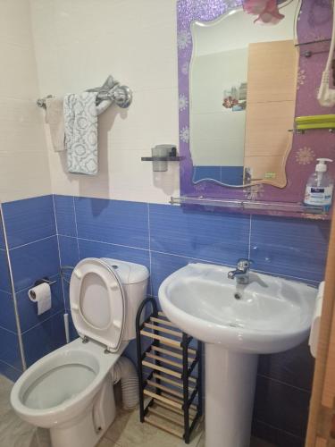 a bathroom with a toilet and a sink at APPARTEMENT DE LUXE 3 Façades in Ben Slimane