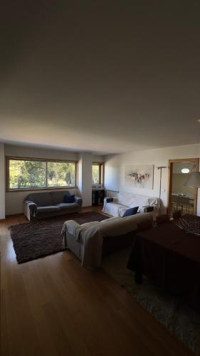 a living room with two beds and a couch at Luxury apartment in Espinho