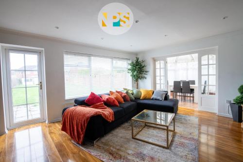 a living room with a couch and a table at 2026 Traveller Award Winner, The Laurels - HS2 Contractors, NEC, BHX, Free Parking in Marston Green