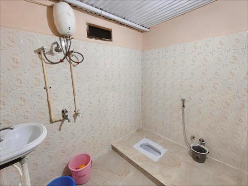 a bathroom with a sink and a toilet at Prime Area 1AC Room Budget Stay in Bhopal