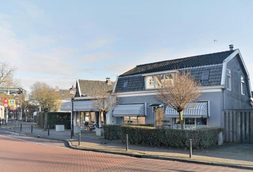 a building with solar panels on the side of a street at Abcoude city center in Abcoude