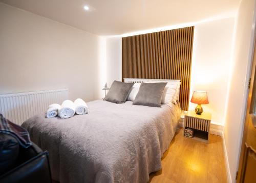 a bedroom with a bed with two pillows on it at Aethelred Annexe - New Build with Full Amenities in Winchester