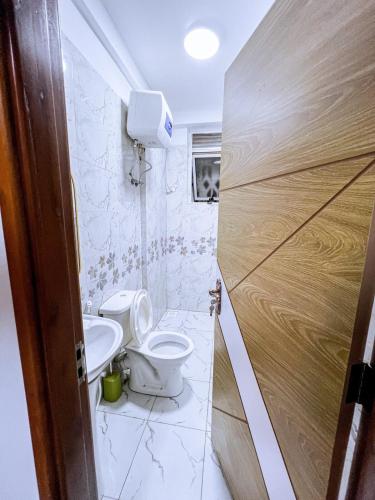 a bathroom with a toilet and a sink at Eliana Apartment in Kampala