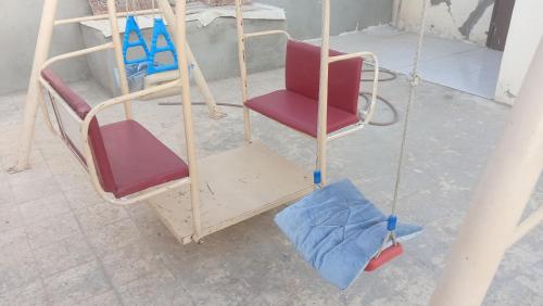 an overhead view of two chairs and a swing at سوما للشقق المفروشه Soma apt in Al Madinah