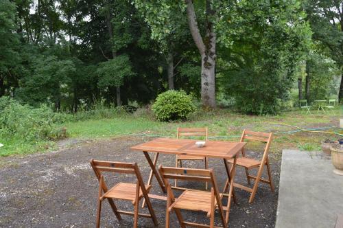 a wooden table with three chairs at L'Escalère in Arnaud-Guilhem