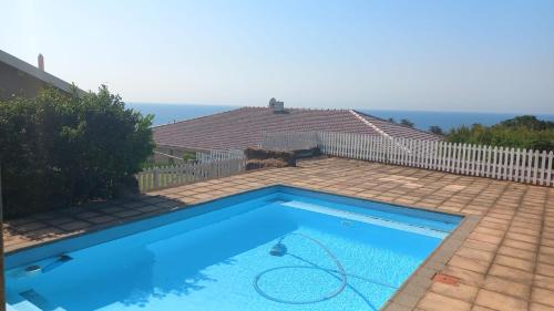 a blue swimming pool in a yard with a fence at 21A on Edgerton in Freeland Park