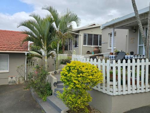 a white fence in front of a house at 21A on Edgerton in Freeland Park