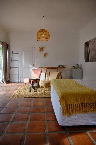 a bedroom with a bed and a table and chairs at MM Good Times in Gansbaai