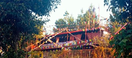 a building under construction with trees in the foreground at Everest Home Stay Temal Kalimati Tower in Thapathali