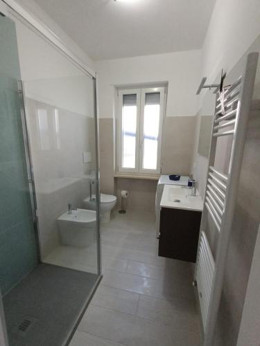 a bathroom with a shower and a sink and a toilet at Gfamily affittacamere in Alba