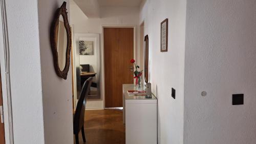 a hallway with a room with a mirror and a dresser at Pescadores GuestHouse in Costa da Caparica