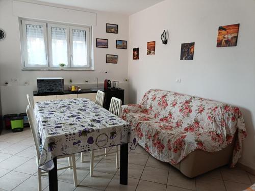 a living room with a table and a couch at Gfamily affittacamere in Alba