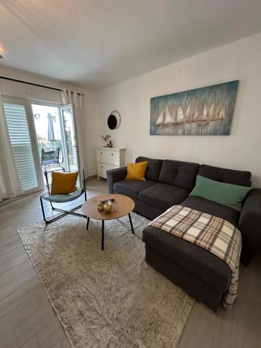a living room with a couch and a table at Apartman Dukić in Okrug Gornji