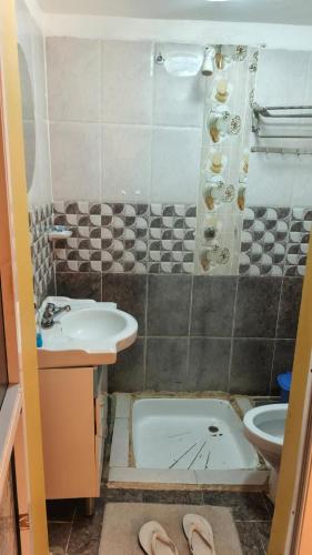 a bathroom with a sink and a shower and a toilet at Sandfields Lodwar Resort and Spa in Lodwar