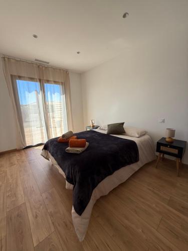 a bedroom with a large bed and a large window at Chez Claudine & Adrien in Figari