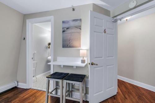 a room with a white door and two stools at Tandem Bike Inn in Belmar