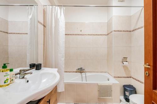a bathroom with a sink and a bath tub at Modern Elegance & Moroccan Charm - Gueliz Center in Marrakech