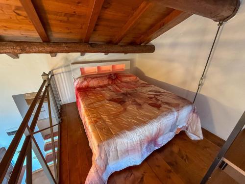 a bed in a room with a ladder at Welcome traveller Benaco Chalet in Torri del Benaco