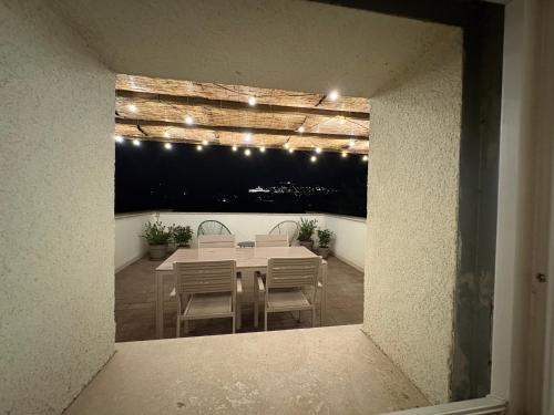 a dining room with a table and chairs and lights at Assisi Panorama Luxe in Assisi
