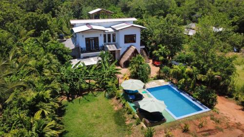 an aerial view of a house with a swimming pool at Dew Ashi Homestay in Sigiriya