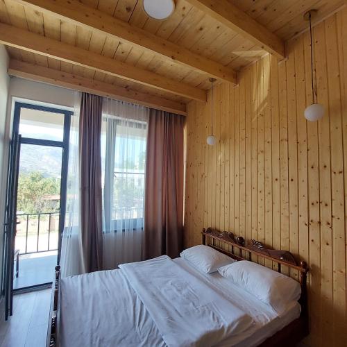 a bedroom with a bed in a room with a window at Spitak tun in Ijevan