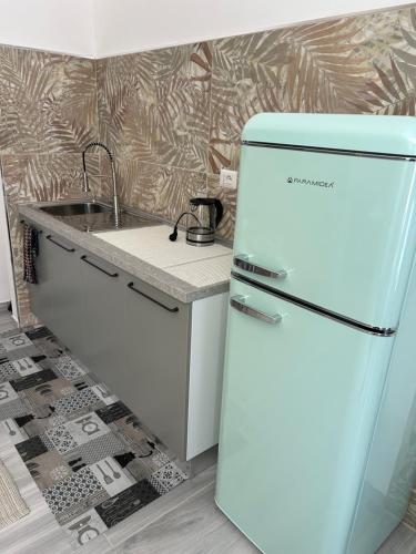 a white refrigerator in a kitchen with a sink at Studio apartment in Fossato di Vico 