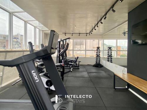 a gym with treadmills and a treadmill at Living in Poços de Caldas