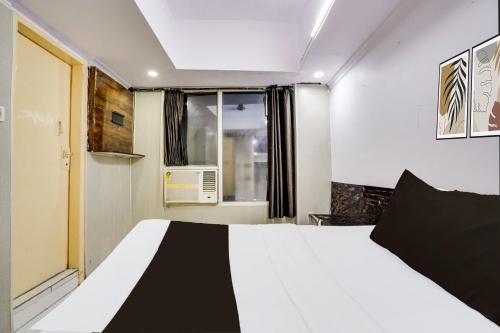 Ένα ή περισσότερα κρεβάτια σε δωμάτιο στο Hotel O HAPPY STAY INN