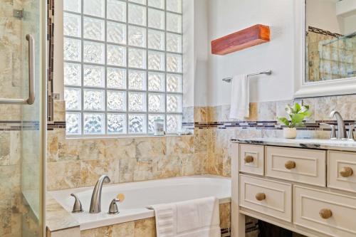 a bathroom with a tub and a sink and a shower at Modern 4BR Home w WiFi by Dell Diamond in Round Rock