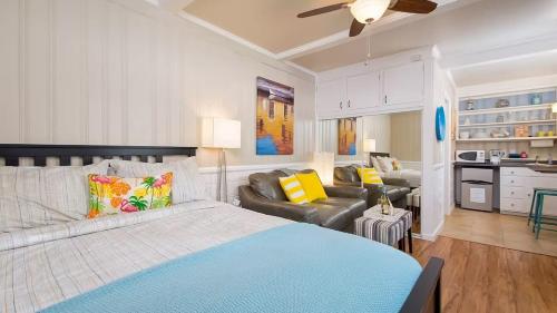 a bedroom with a bed and a living room at Coastal Bayside Condo Walkable to Sand Surf in Newport Beach