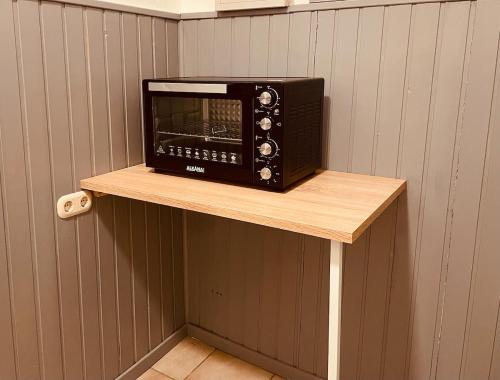 a microwave oven sitting on a shelf on a wall at Haus Nordwind in Wilhelmshaven