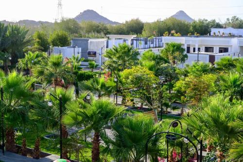 a view of a resort with palm trees and buildings at منتجع حياه رويال الطائف in Ash Shuwaybiţ