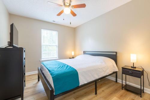 a bedroom with a bed and a ceiling fan at Family & Couples Getaway Near Lake Norman Firepit King Suite in Troutman
