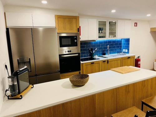 a kitchen with a refrigerator and a counter top at Casa da Mó - Conforto, Charme e Piscina privada no Coração do Alentejo in Beringel