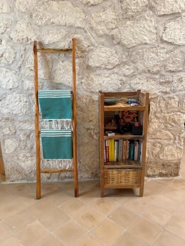 a book shelf next to a wall with at Turquoise Brick Surf House in Essaouira