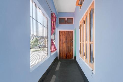 a hallway of a house with a door and windows at SPOT ON S.D.S GUEST HOUSE in Guwahati