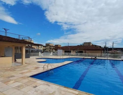 a large swimming pool with blue water at Apartamento COP 30 - até 6 pessoas in Ananindeua