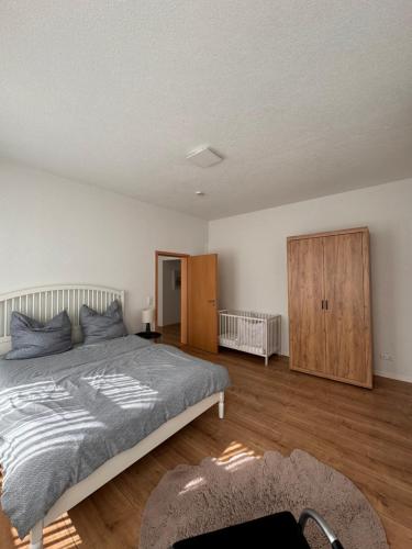 a bedroom with a large bed and a wooden floor at 2 Bedroom Apartment at Grenzach train station in Grenzach-Wyhlen