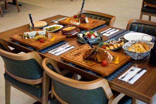 a wooden table with food on top of it at Hotel & Restaurant HAREA in Suharekë