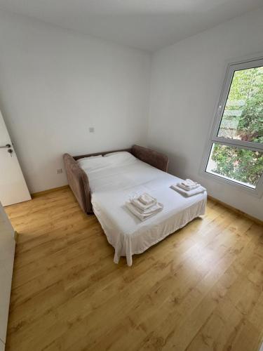a bedroom with a bed in a room with a window at Peyia Sunset Luxury in Paphos City