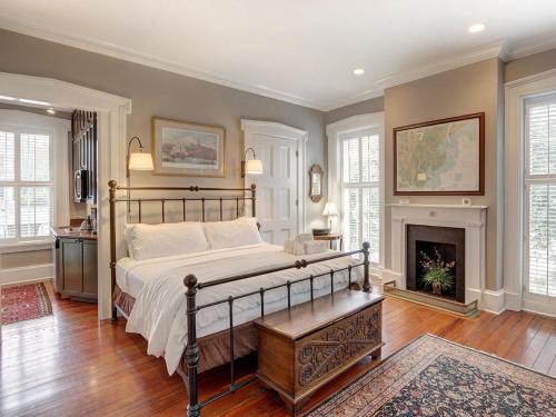 a bedroom with a bed and a fireplace at Bird Baldwin Twelve Oaks in Savannah
