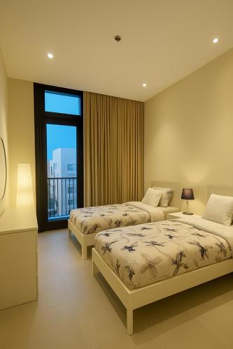 a hotel room with two beds and a large window at The Nest Loft in Riyadh