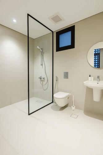 a bathroom with a shower and a toilet at The Nest Loft in Riyadh