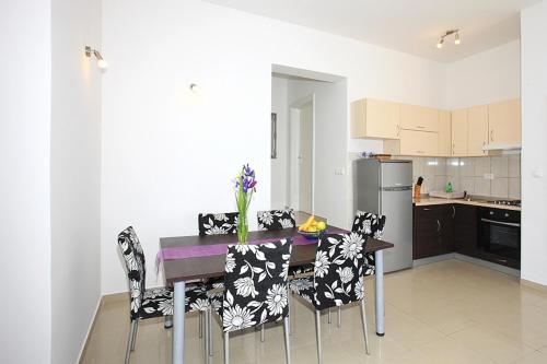a kitchen with a dining room table and chairs at Apartment Stipan in Bibinje