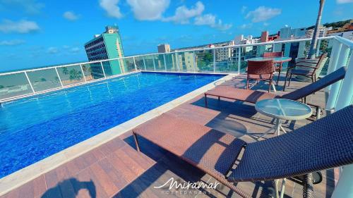 a swimming pool on the roof of a building at One Cabo Branco-Poucos Metros da Praia in Tambaú