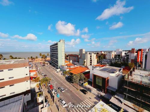 an aerial view of a city with buildings and a street at One Cabo Branco-Poucos Metros da Praia in Tambaú
