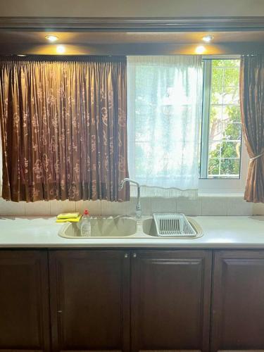 a kitchen with a sink and a window at Vintage house overlooking the statue of Leonidas in Sparti