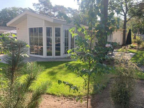 a garden cabin with a view of a yard at Chalet de Veluwe Europarcs in Otterlo
